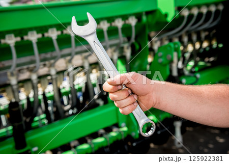 The mechanics repair combine harvester. Modern agricultural machinery The mechanics repair combine harvester. Modern agricultural machinery 125922381