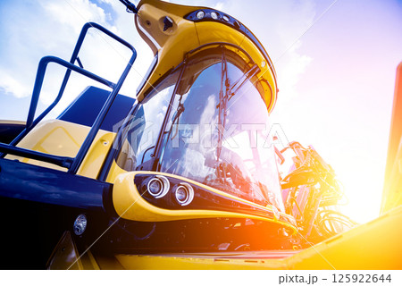 Modern agricultural machinery and equipment. Yellow agricultural harvester. Modern agricultural machinery and equipment. Yellow agricultural harvester. 125922644