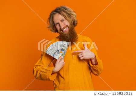 Rich happy man winner waving money dollar cash like a fan, big income wealth success business 125923018