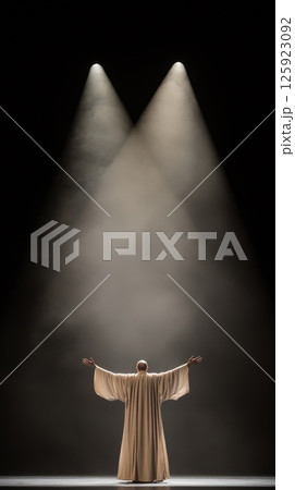 Silhouetted figure in dramatic theater spotlight 125923092