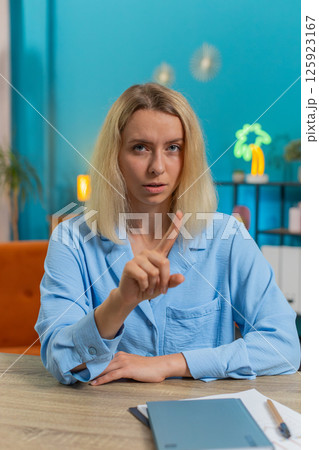 Business woman shakes finger saying No be careful avoid danger mistake disapproval sign at office 125923167