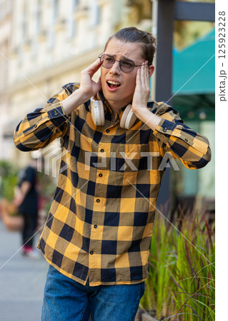 Exhausted man male rubbing temples to cure headache problem suffering from tension migraine stress Exhausted man male rubbing temples to cure headache problem suffering from tension migraine stress 125923228