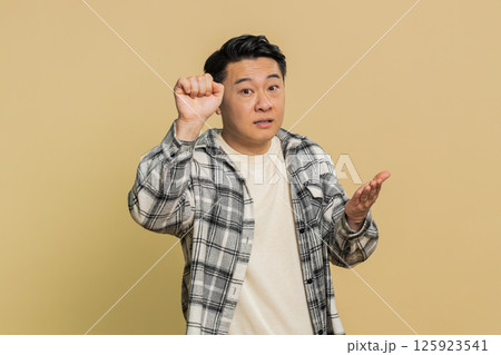 Confused excited Asian man knocking door gesture asking who is at home, feeling embarrassed, no idea Confused excited Asian man knocking door gesture asking who is at home, feeling embarrassed, no idea 125923541