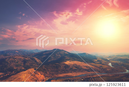 Top view of colorful mountain slopes and river Stryi at sunset. Beautiful landscape. Carpathians, Carpathian Ruthenia, Ukraine Top view of colorful mountain slopes and river Stryi at sunset. Beautiful landscape. Carpathians, Carpathian Ruthenia, Ukraine 125923611