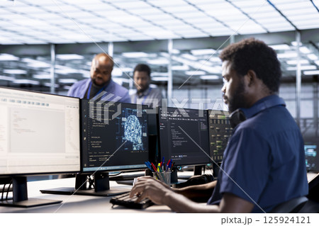 Server farm IT specialist using AI systems to input data faster during complex computational tasks. Software developer in data center using artificial intelligence parallel processing tech 125924121