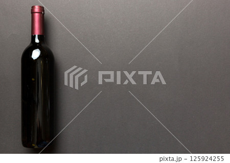 One Bottle of red wine on colored table. Flat lay, top view wth copy space 125924255