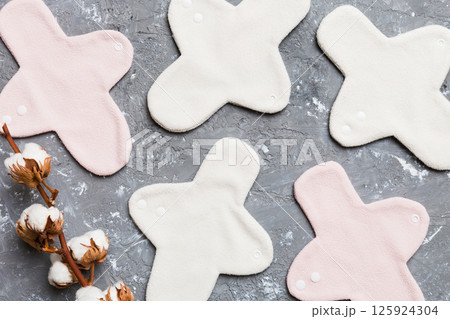 set of colorful bright reusable menstrual pads with cotton flower. zero waste woman periods concept top view with copy space set of colorful bright reusable menstrual pads with cotton flower. zero waste woman periods concept top view with copy space 125924304