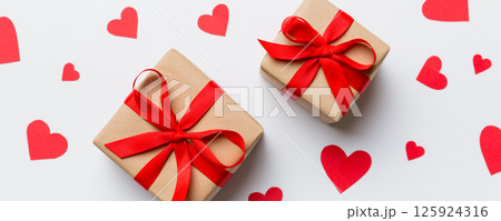 Valentine day composition Background: red gift box with bow and heart. Christmas present. View from above. Holday greeting card 125924316
