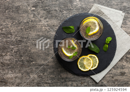 Healthy breakfast or morning with chia seeds lemon and mint on table background, vegetarian food, diet and health concept. Chia pudding with lemon and mint 125924594