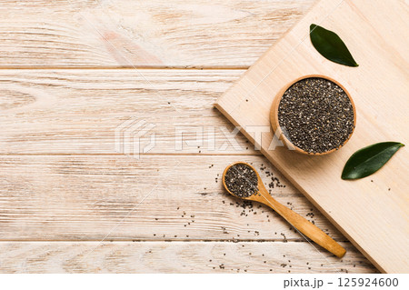 Chia seeds in bowl and spoon on colored background. Healthy Salvia hispanica in small bowl. Healthy superfood 125924600