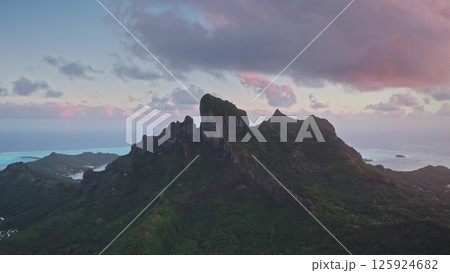 Aerial drone majestic mount Otemanu, Bora Bora island in French Polynesia. Volcanic mountain peaks under vibrant colorful sunset sky clouds. Popular travel destination, remote wild paradise 125924682