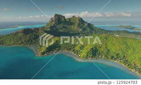 Breathtaking drone footage revealing the stunning beauty of Bora Bora, featuring iconic mount Otemanu, crystal-clear turquoise waters, vibrant coral reefs, and lush vegetation Breathtaking drone footage revealing the stunning beauty of Bora Bora, featuring iconic mount Otemanu, crystal-clear turquoise waters, vibrant coral reefs, and lush vegetation 125924703