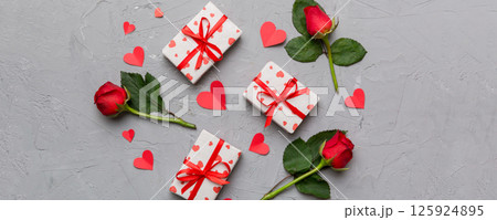 Kraft Gift box with beautiful red ribbon and rose, concept of Valentine day, anniversary, mother day and birthday greeting, copy space, top view 125924895