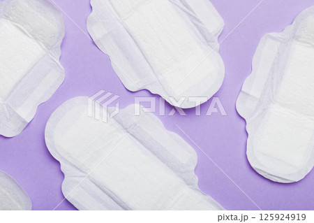 Women hygiene products or sanitary pad on colored background. Pastel color. Closeup. Empty place for text. Female daily hygiene Women hygiene products or sanitary pad on colored background. Pastel color. Closeup. Empty place for text. Female daily hygiene 125924919