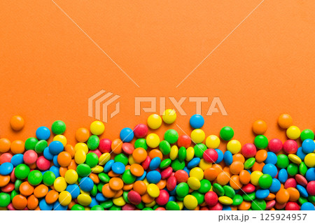 Mixed collection of colorful candy, on colored background. Flat lay, top view. frame of colorful chocolate coated candy 125924957