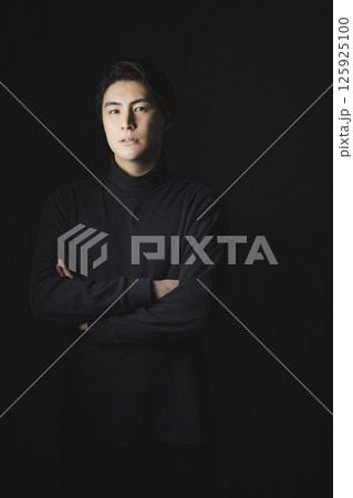 黒バックの男性のポートレイト 125925100