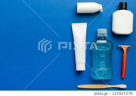 Composition with bath cosmetics on table. razor, toothpaste, soap, gel, toothbrush, mouthwash and other various accessories. Cosmetics for skin health. Bath Mockup for your logo 125925376