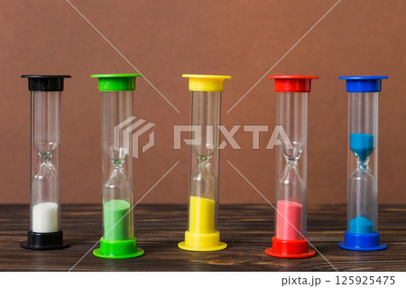 hourglass on the table, sand clock as time passing concept for business deadline, copy space hourglass on the table, sand clock as time passing concept for business deadline, copy space 125925475