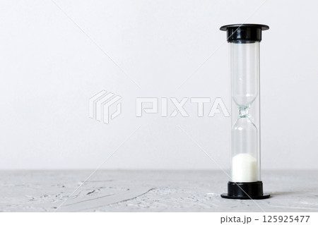 hourglass on the table, sand clock as time passing concept for business deadline, copy space 125925477