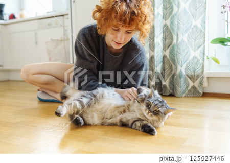 young woman hugging pet domesticated cat young woman hugging pet domesticated cat 125927446