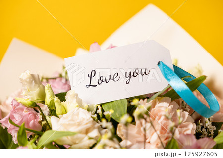 romantic floral bouquet with love message on gift tag, perfect for valentine's day, anniversary, or heartfelt confession 125927605
