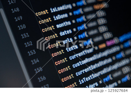 close-up of computer screen with colorful javascript code, focus on const keyword, software development and programming 125927684