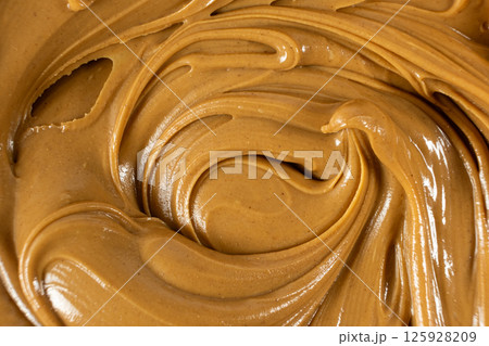 Smooth Nut Butter Swirl as Culinary Background 125928209