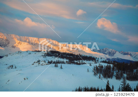 Winter twilight plateau, snowy mountains at dusk Winter twilight plateau, snowy mountains at dusk 125929470