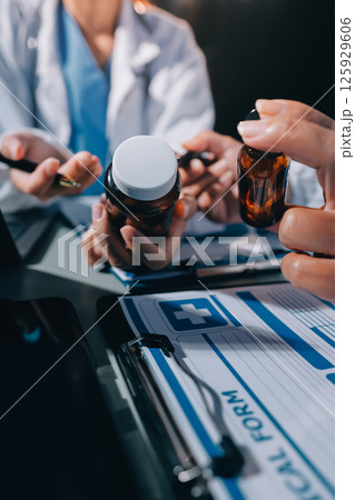 Male and female doctors are having a meeting in a hospital room. 125929606
