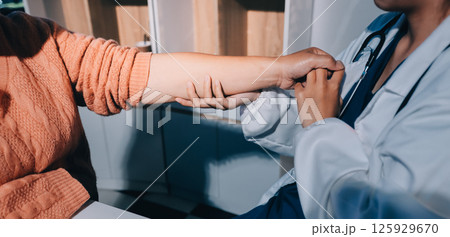 Orthopedist examining patient in hospital 125929670
