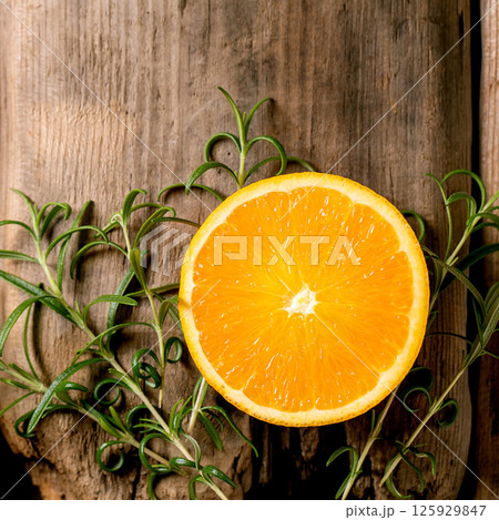 Fresh organic sliced orange and rosemary branches 125929847