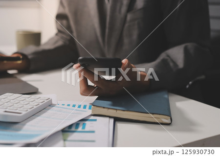 Working from home, Closeup business woman using laptop computer and analyzing financial report. 125930730