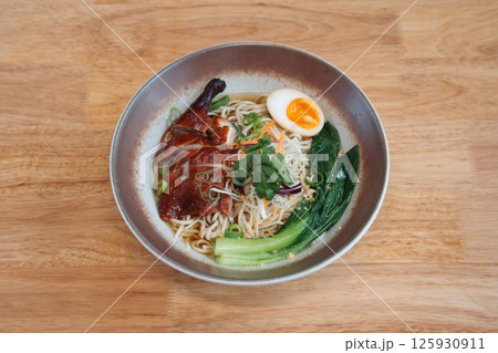 noodles with duck egg and vegetables. Delicious freshly prepared meal, perfect for menus, restaurants, or food delivery concepts. 125930911