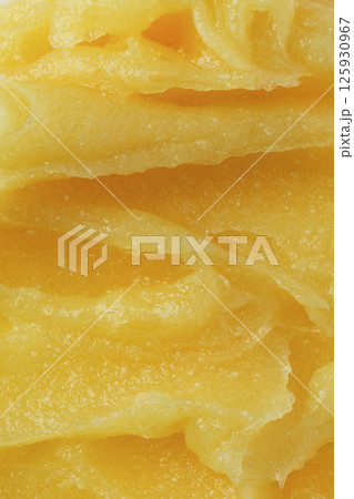 Abstract yellow sugar body exfoliating scrub texture. Melon scrub for body or face pilling. Skin care body moisturizer scrub background. 125930967