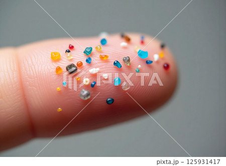 A hand holding a handful of colorful beads A hand holding a handful of colorful beads 125931417
