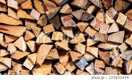 A pile of wood with many pieces of wood stacked on top of each other 125931474
