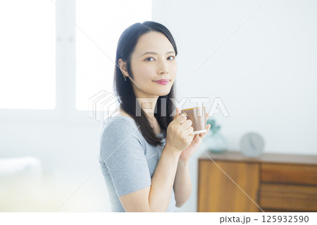 部屋でコーヒーを若い女性 125932590