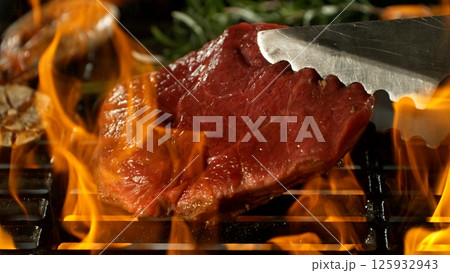 Close-up of Beef Steak on a Grill with Roaring Flames Close-up of Beef Steak on a Grill with Roaring Flames 125932943
