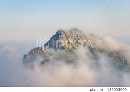 A mountain in the clouds A mountain in the clouds 125933009