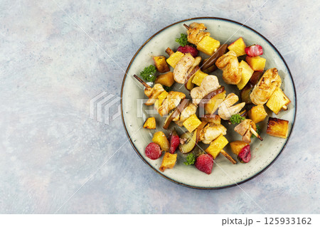 Chicken meat with pineapple on skewers. Chicken meat with pineapple on skewers. 125933162