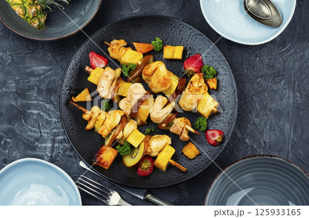 Meat skewers - grilled chicken breast and pineapple. 125933165