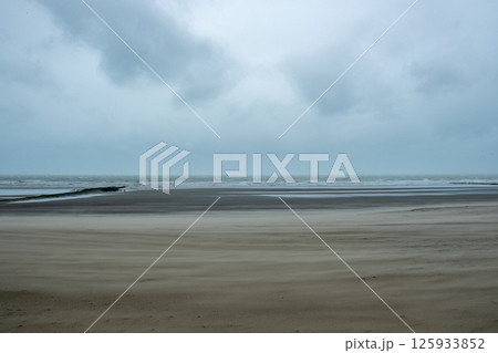 A captivating and serene calm seascape beautifully unfolds beneath the cloudy skies above A captivating and serene calm seascape beautifully unfolds beneath the cloudy skies above 125933852