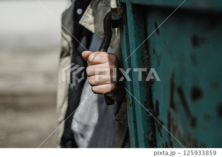The worker's hands, covered with sweat and dust, demonstrate endless determination. The worker's hands, covered with sweat and dust, demonstrate endless determination. 125933859