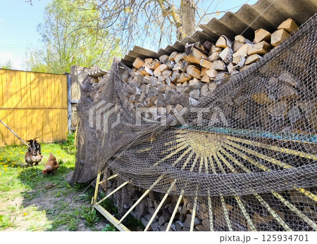 Set of cut firewood. Piles of firewood Firewood stack. A woodpile in the yard. Set of cut firewood. Piles of firewood Firewood stack. A woodpile in the yard. 125934701