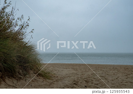 A beautiful beach scene on an overcast day evokes a sense of calmness and peace 125935543