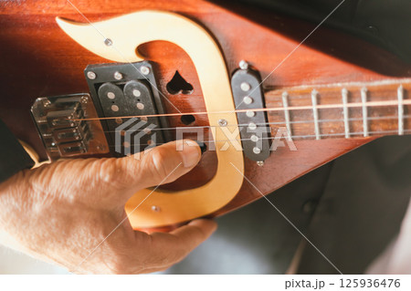 Close up hand playing Thai Mandolin Close up hand playing Thai Mandolin 125936476