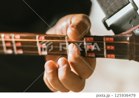 Close up hand playing Thai Mandolin 125936479