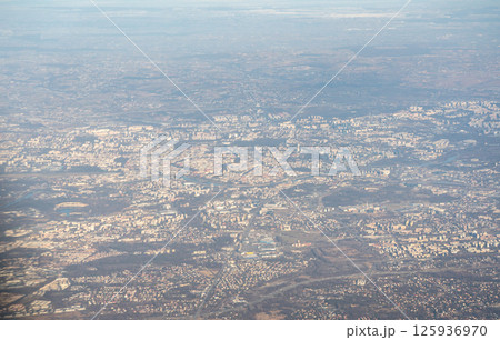 Plane window view of snow Polish fields and villages, Krakow suburbs, aircraft fly landscape Plane window view of snow Polish fields and villages, Krakow suburbs, aircraft fly landscape 125936970