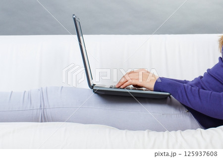 Hands of woman with laptop. Relaxing or working with computer Hands of woman with laptop. Relaxing or working with computer 125937608