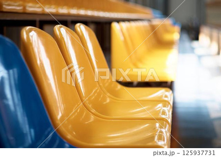 A grandstand at a hippodrome for horse racing. Rows of seats in a stadium A grandstand at a hippodrome for horse racing. Rows of seats in a stadium 125937731